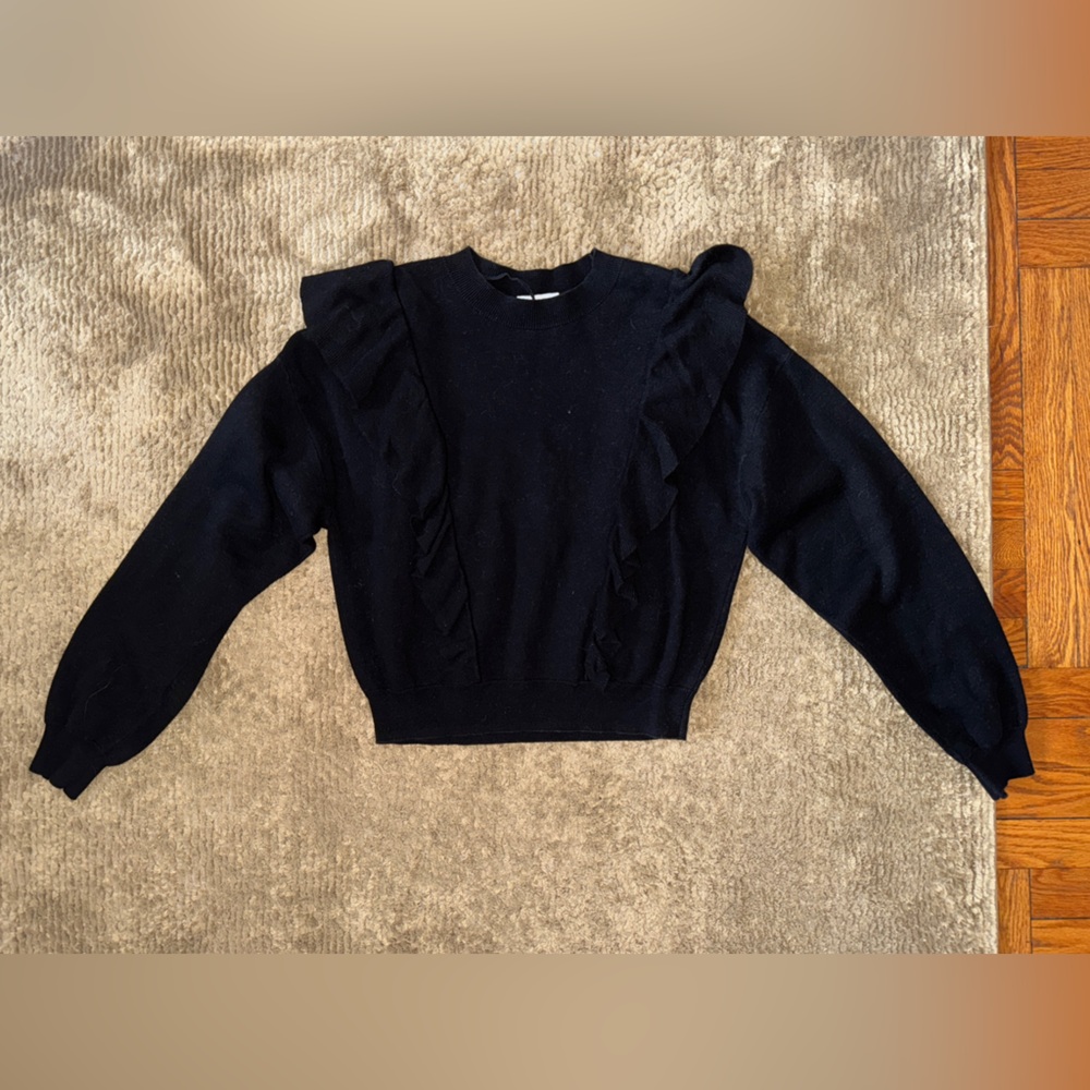 Black knit sweater with ruffle detail